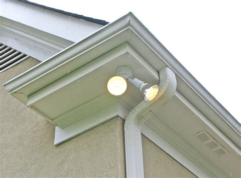 install junction box for flood light under eaves|installing flood lights vinyl soffit.